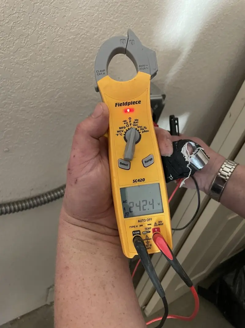 Voltage testing with clamp meter during Outlet Installation in Everett